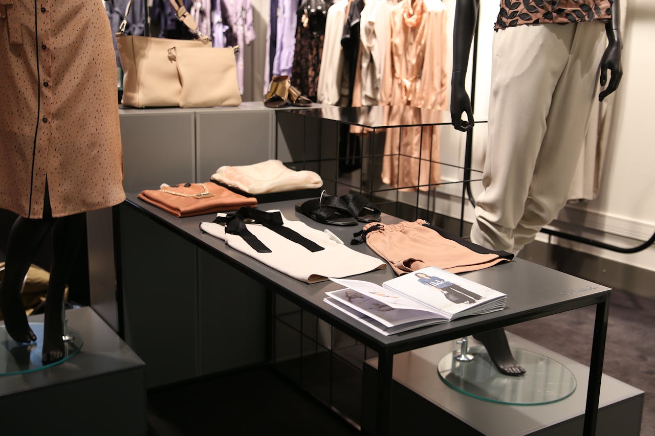 Professional style consultant reviewing clothing options with client in elegant showroom